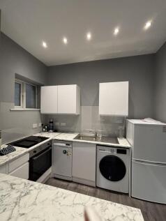 A modern, well-maintained kitchen with ample na...