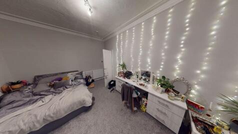 A cozy and well-maintained bedroom featuring a ...