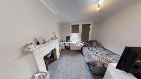 Bright and tidy bedroom featuring a cozy double...