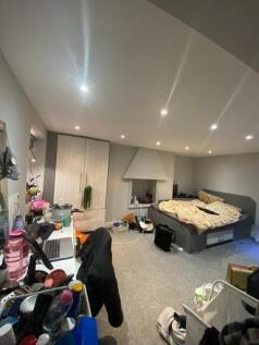 A spacious and contemporary living room with mo...