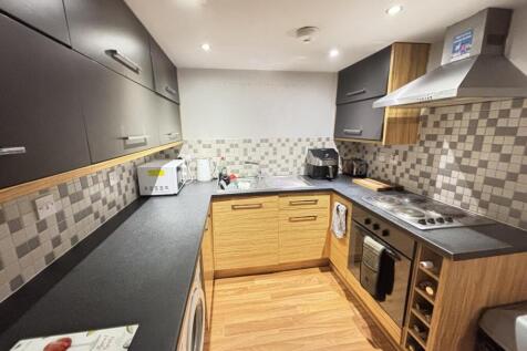 Bright and modern kitchen with ample workspace,...