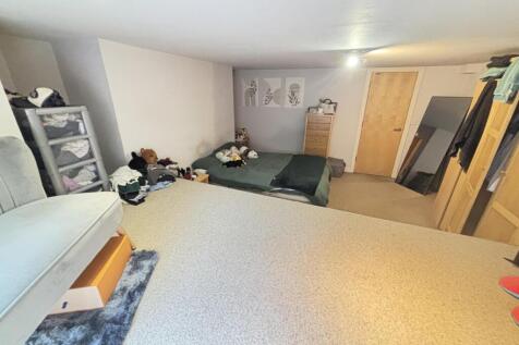 A cozy bedroom featuring a double bed, cluttere...