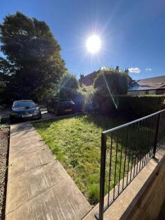 Sunny front garden and driveway with parking sp...