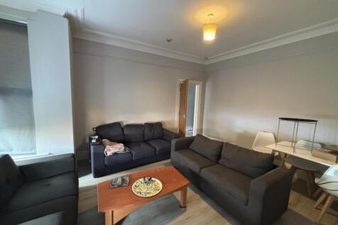 Spacious, modern living room with comfortable m...