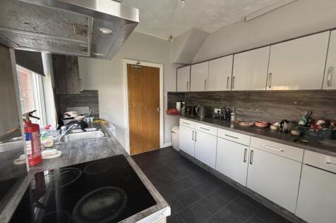 Bright galley-style kitchen with long runs of w...