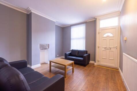 Bright furnished living room with modern seatin...