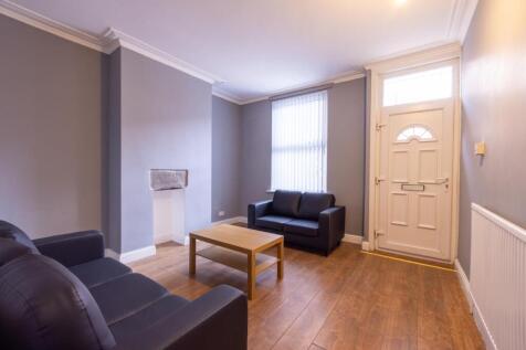 Bright, neutrally decorated living room with ha...