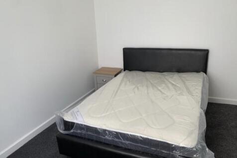 Simple, freshly painted bedroom fitted with a d...