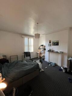 Spacious bedroom with a double bed, neutral dec...