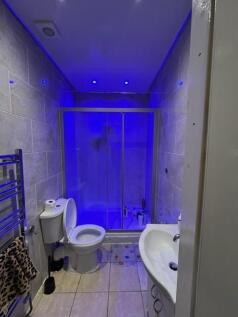 Modern tiled bathroom with walk-in shower, toil...