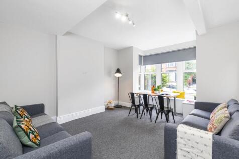 Bright, modern living space with two comfortabl...