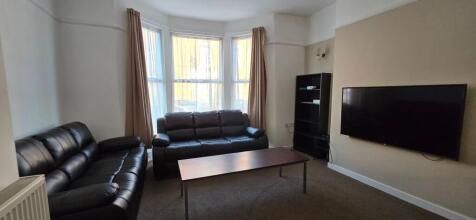 Bright, well-presented living room with a large...