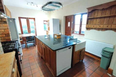 Bright country-style kitchen with a central isl...