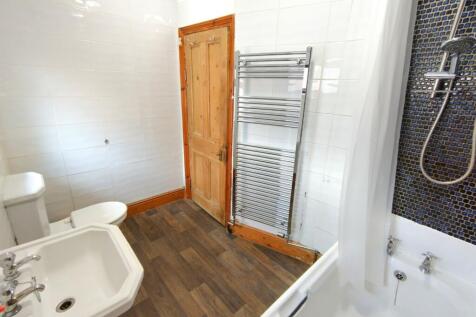 Bright, modern bathroom with a classic white si...