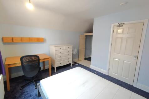 Bright, neatly presented bedroom with a comfort...