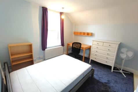 Bright, neatly presented bedroom with a large w...