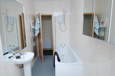 Bright, modern bathroom with a full-length bath...