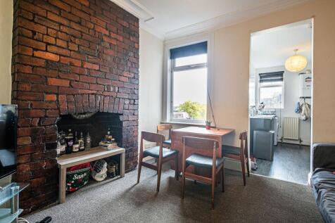 Bright, characterful living room with an expose...