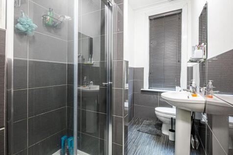 Modern bathroom with walk-in shower, pedestal s...