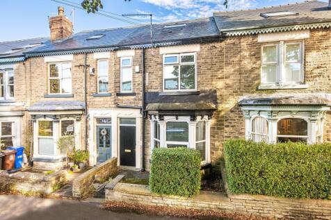 Stone-fronted terraced house with bay windows, ...