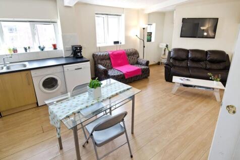 Bright open-plan living area with a compact kit...