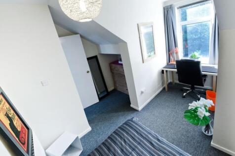 Bright, neatly presented bedroom with a large w...