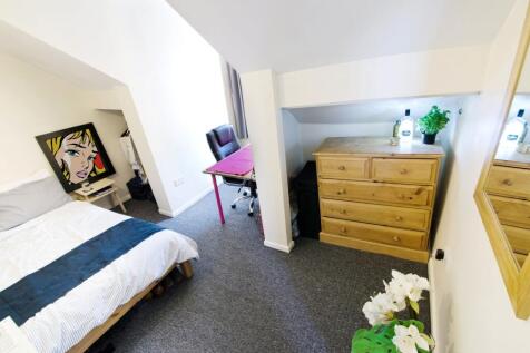 Bright, neatly presented bedroom with a comfort...