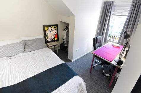 Bright, neatly presented bedroom with a comfort...