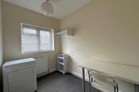 Bright, simply furnished single bedroom with a ...