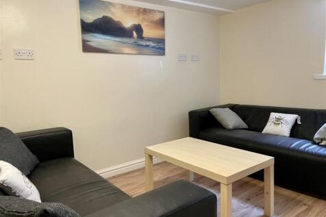 Comfortable communal lounge with two black leat...