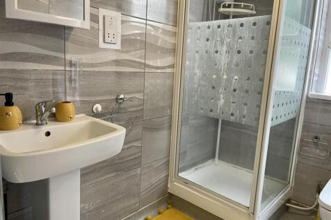 Modern tiled bathroom with a pedestal sink, chr...