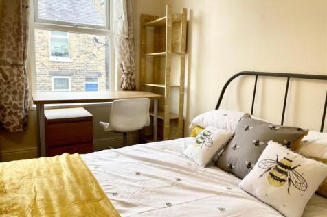 Bright, neatly presented bedroom with a metal-f...