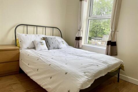 Bright, neatly presented bedroom with a metal-f...