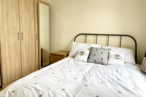 Bright, modern bedroom with a comfortable doubl...