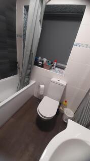 Modern bathroom with a bathtub and shower, whit...