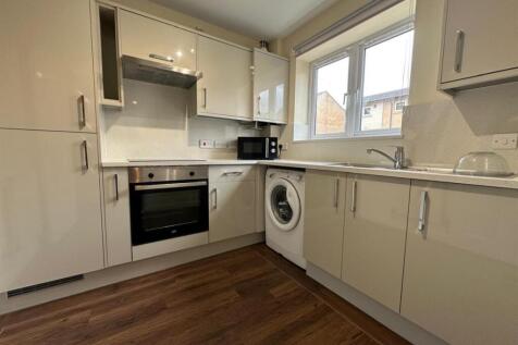 Bright modern kitchen with gloss cabinets, inte...