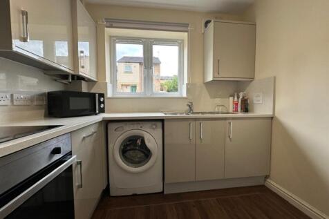 Modern fitted kitchen with gloss cabinets, inte...