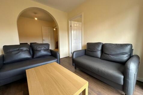 Bright, simply furnished living room featuring ...