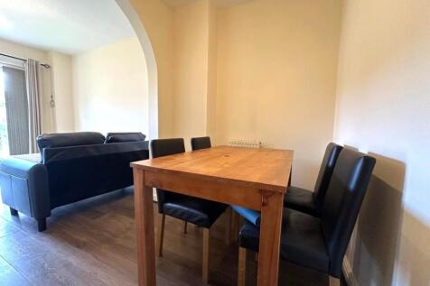 Bright, open-plan living and dining area with w...