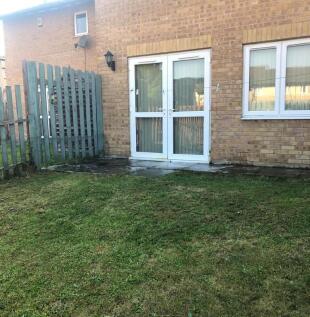 Well-kept rear garden with a lawn, paved patio ...