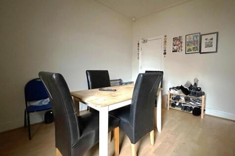 Bright, simply furnished living/dining area wit...