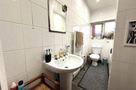 Bright, well-kept bathroom with a pedestal sink...