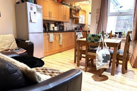 Bright open-plan kitchen and dining area with l...