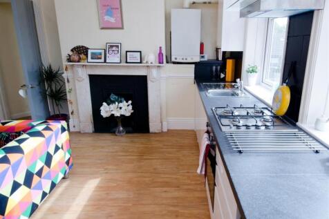Bright, modern kitchen area with a long worktop...