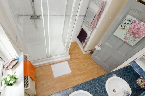 Bright, modern bathroom with a glass-enclosed s...