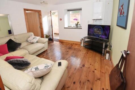 Bright, stylish living room with wooden floors,...