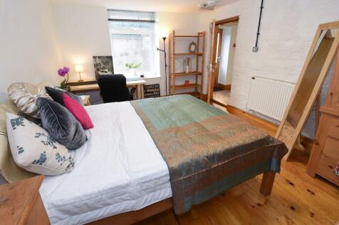 Bright, neatly styled double bedroom with woode...