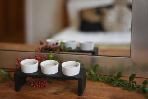 Stylish bedside vignette in a well-lit bedroom ...