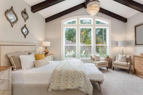 A spacious master bedroom featuring a large uph...