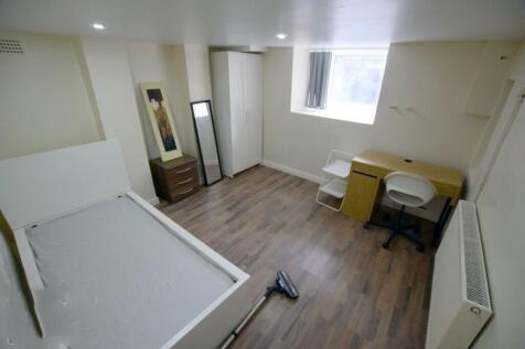 Bright, neutrally decorated bedroom with lamina...